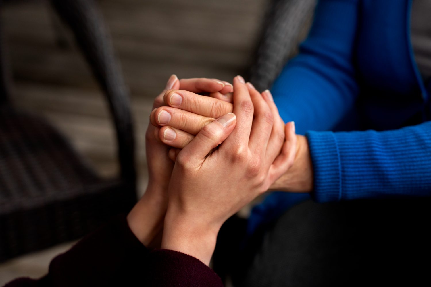 2150445969 Hands holding each other for support